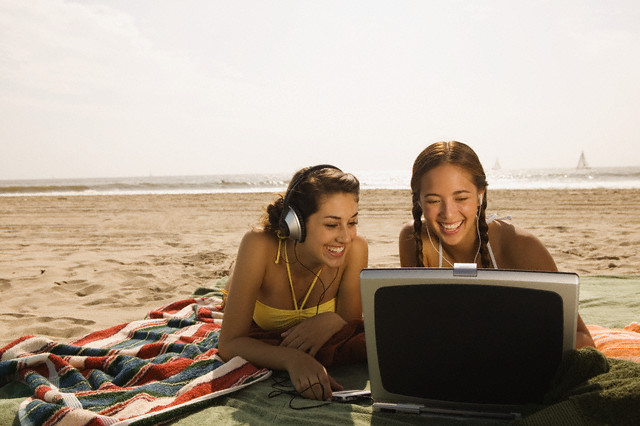 Girls at beach with laptop